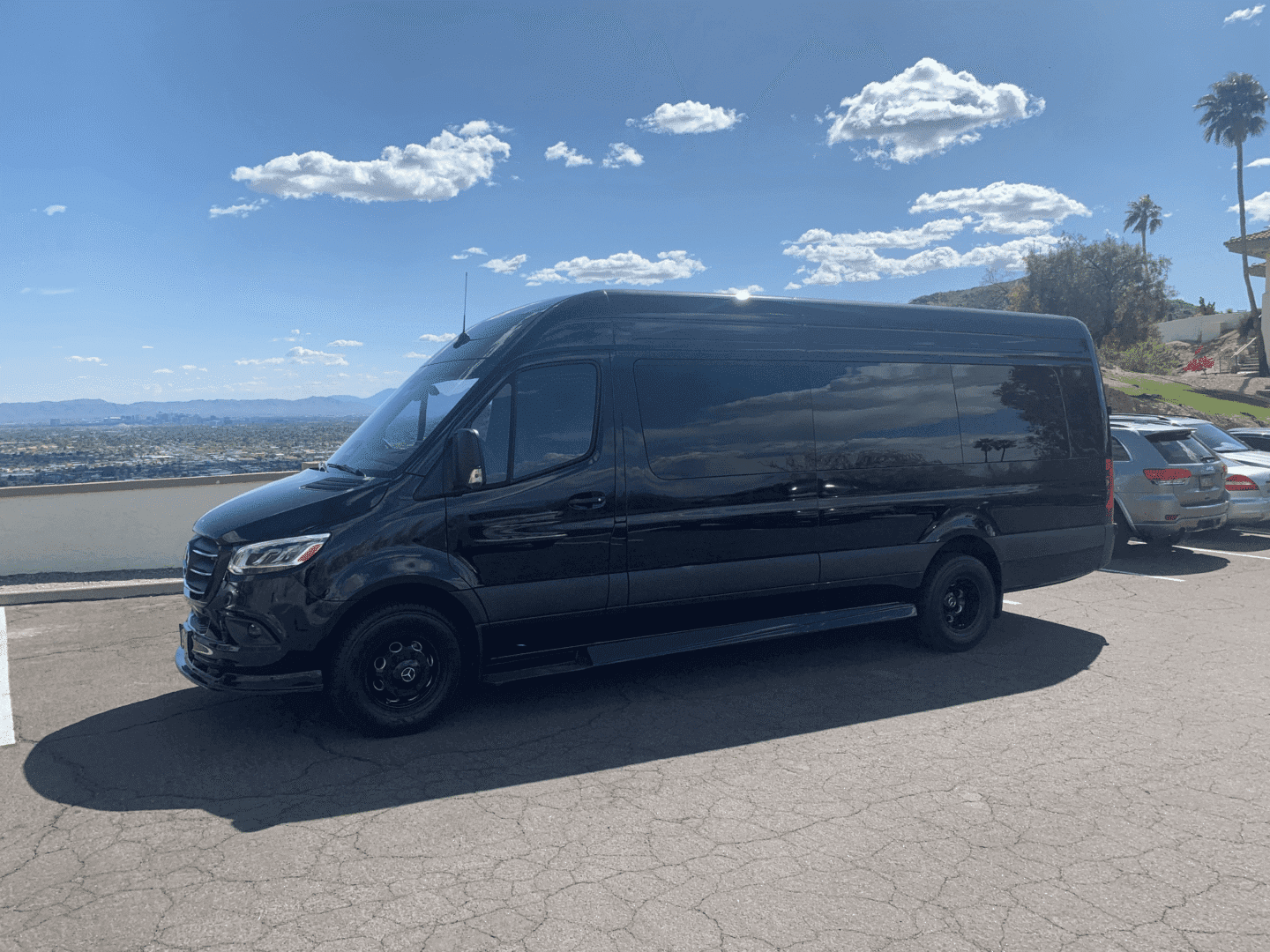 A black van is parked on the side of the road.