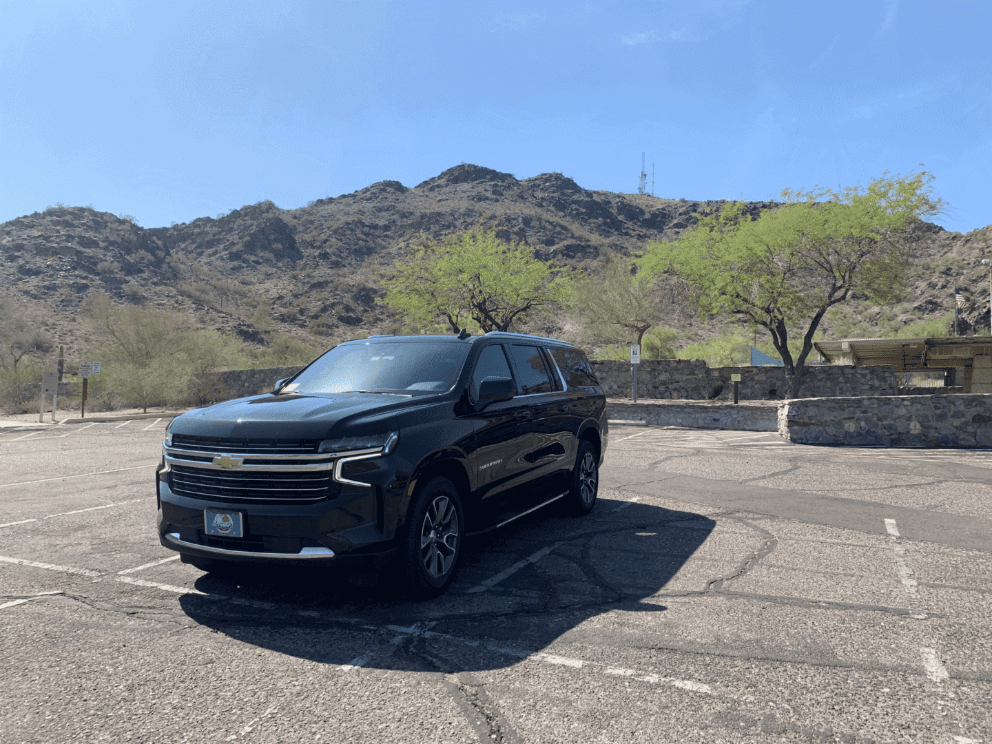 A black suv parked in the parking lot.