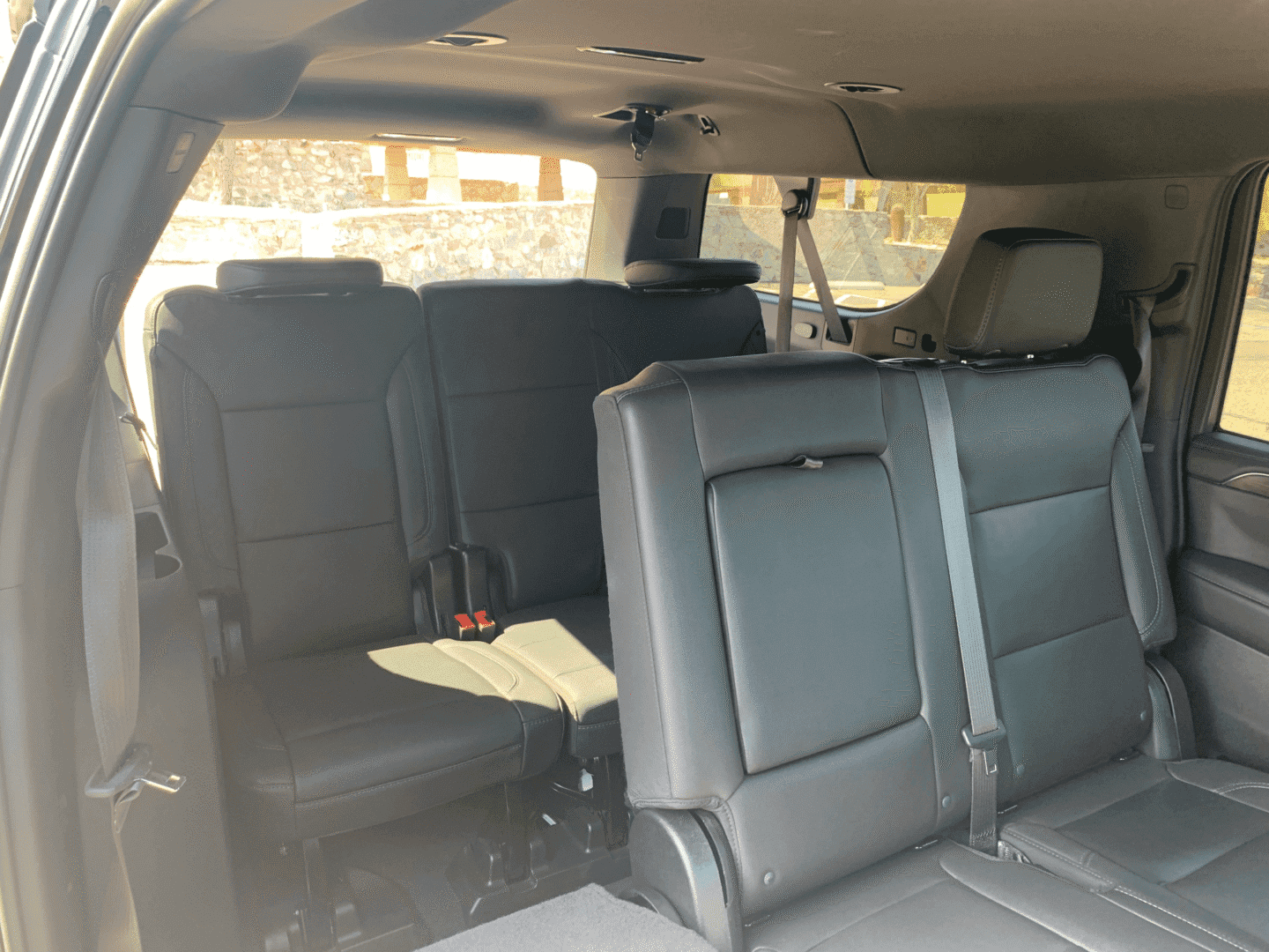 A car with the seats folded down in the back.