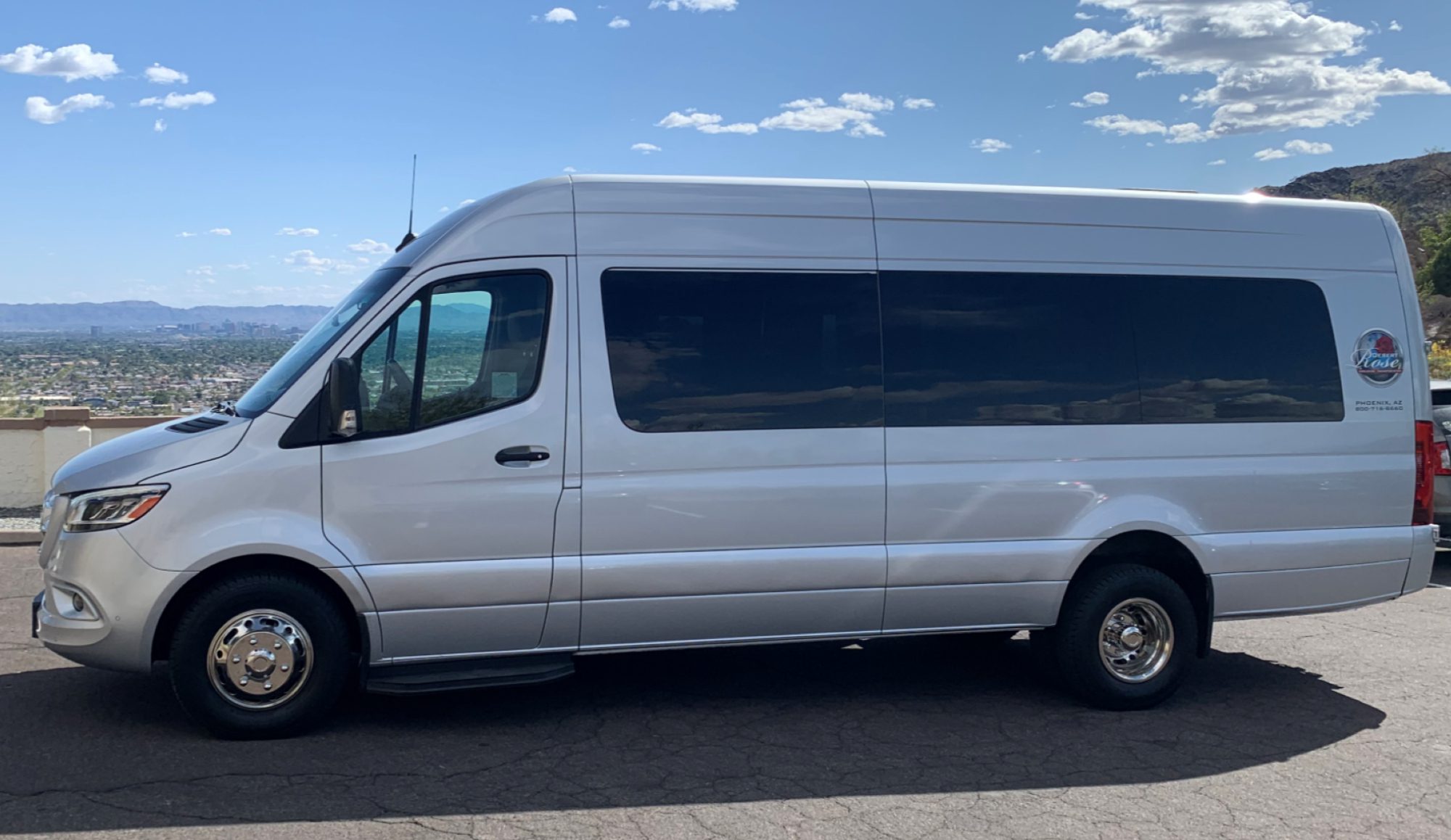 A white van is parked on the side of the road.